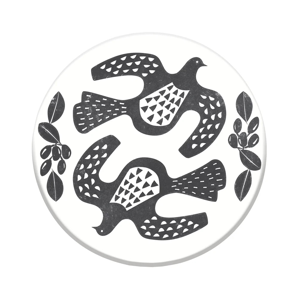 Decorative coaster with black Kereru bird and leaf design on a white background