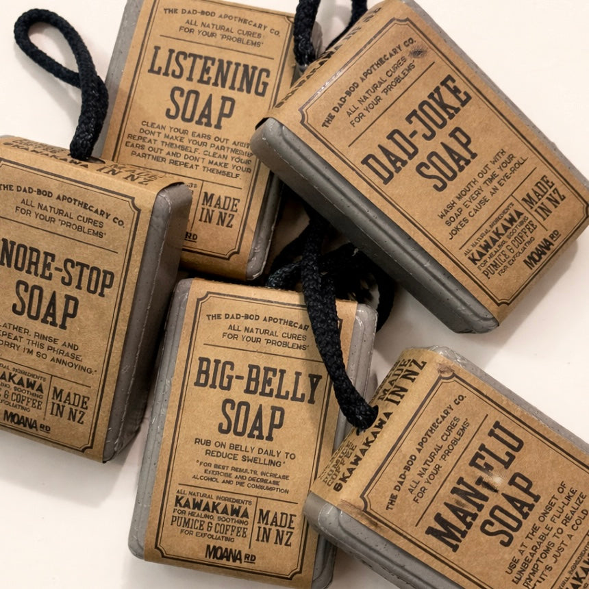 Set of novelty soaps with humorous labels on a white background