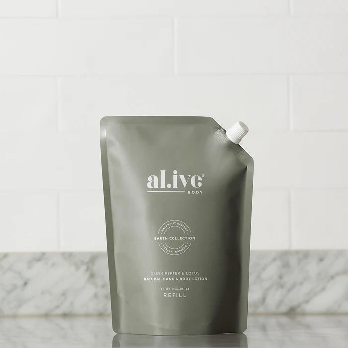 Green refill pouch with 'al.ive' branding on a marble surface.