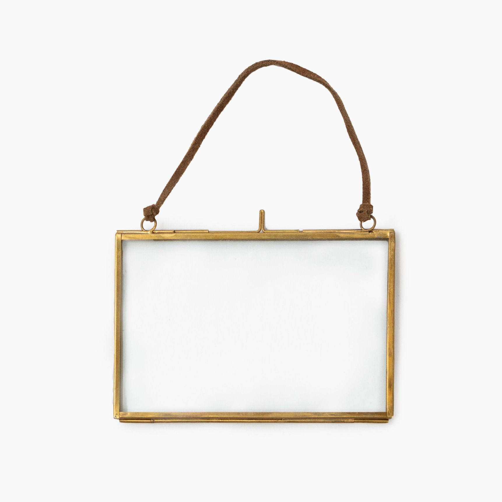 Gold rectangular frame with a string for hanging on a white background