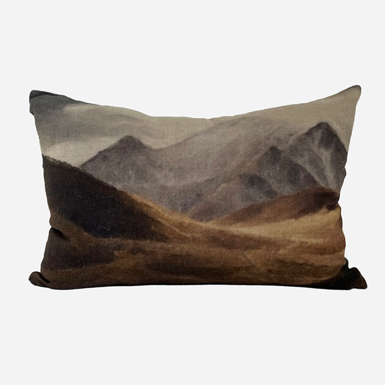 Decorative pillow with mountain landscape design on a white background