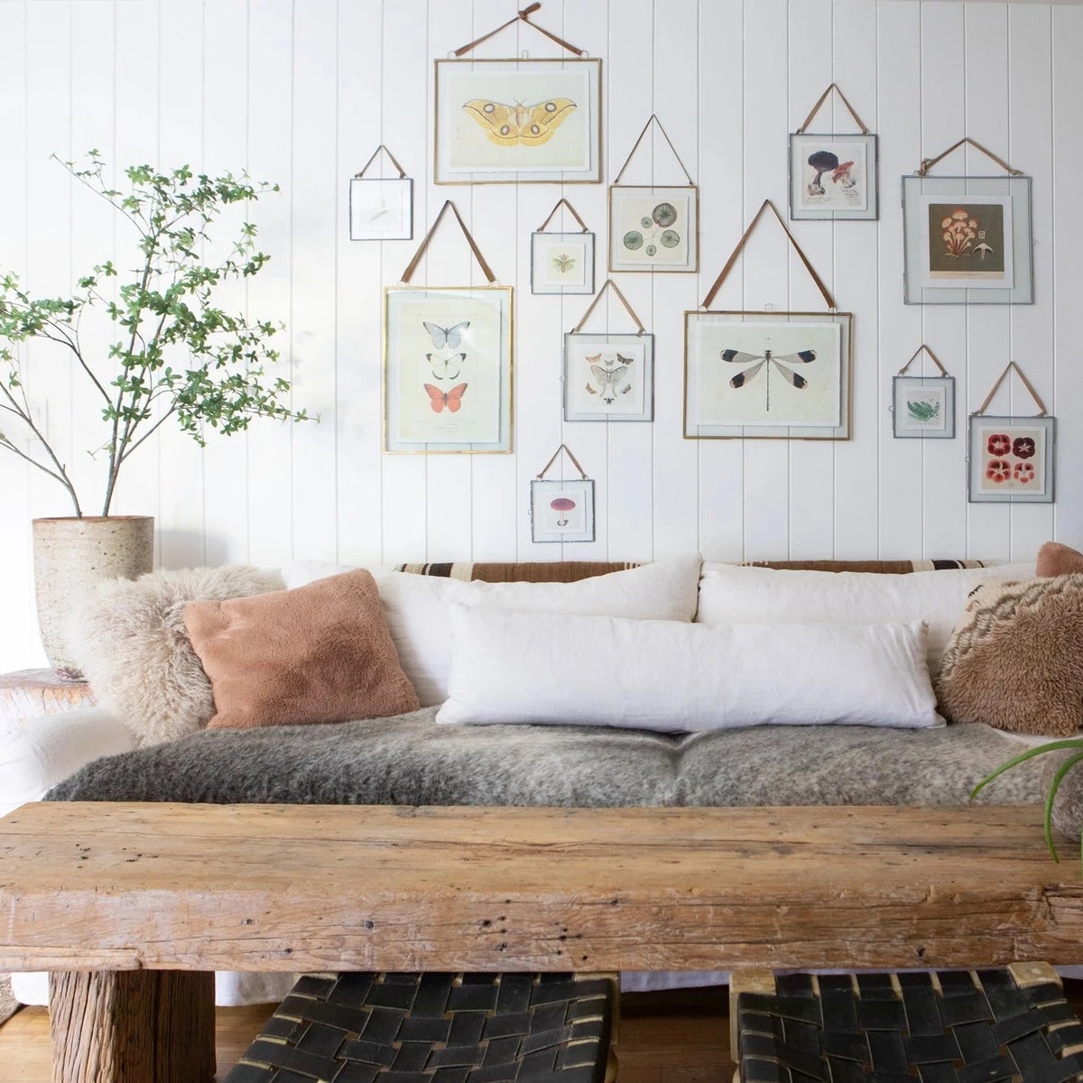 Living room with a wooden table, sofa, and wall art
