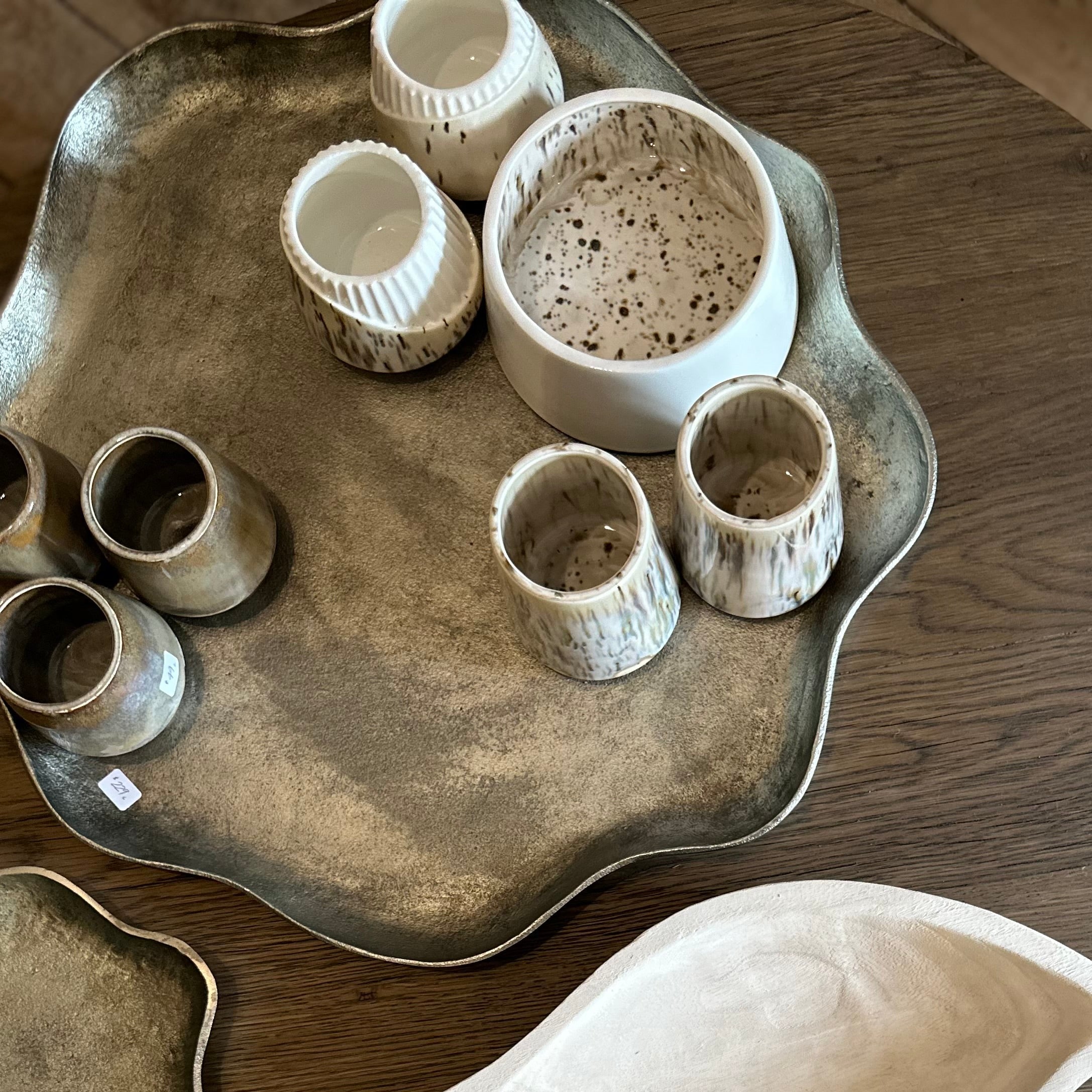 Collection of ceramic bowls and a tray on a wooden surface