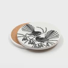 Two coasters with Fantail bird design on a white background