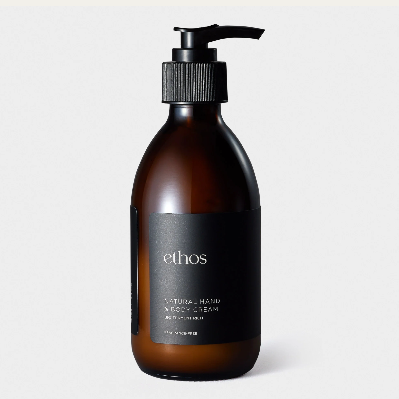 Brown bottle with pump dispenser labeled 'ethos' on a light gray background