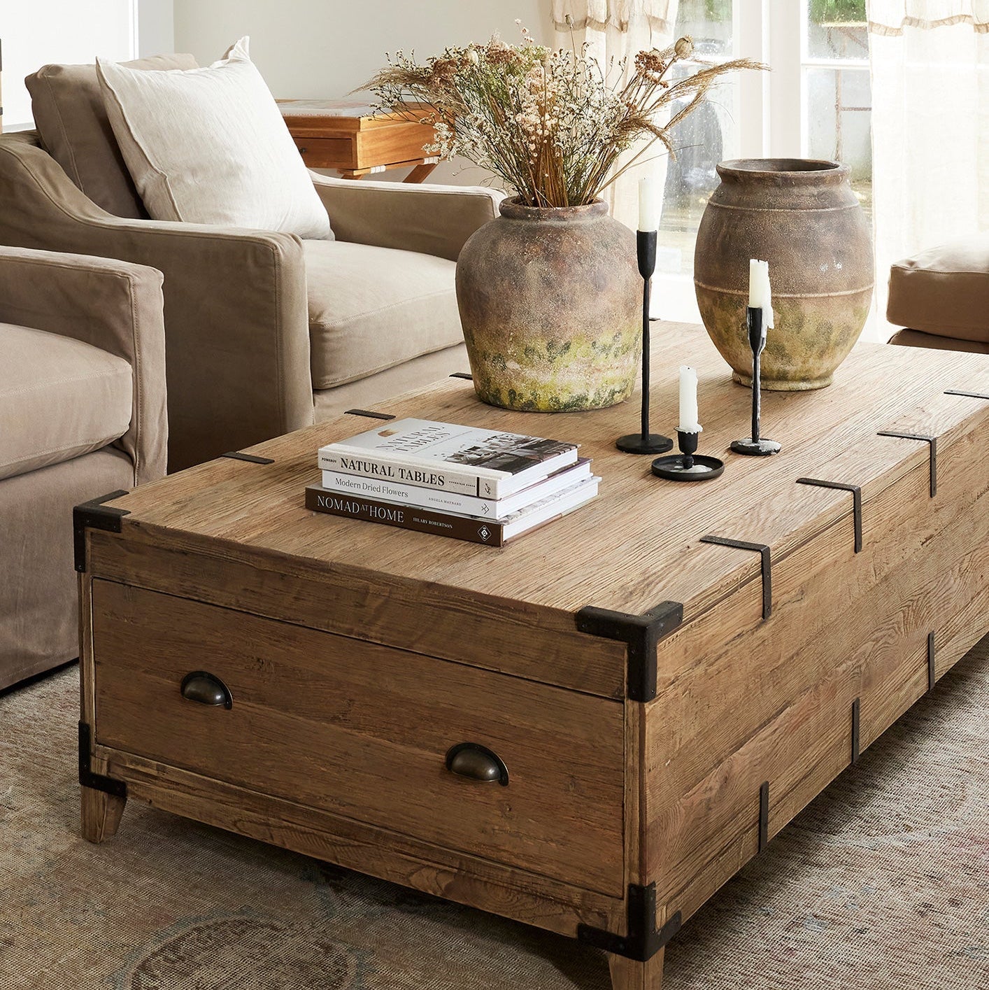 Wooden coffee table with decorative items in a living room setting