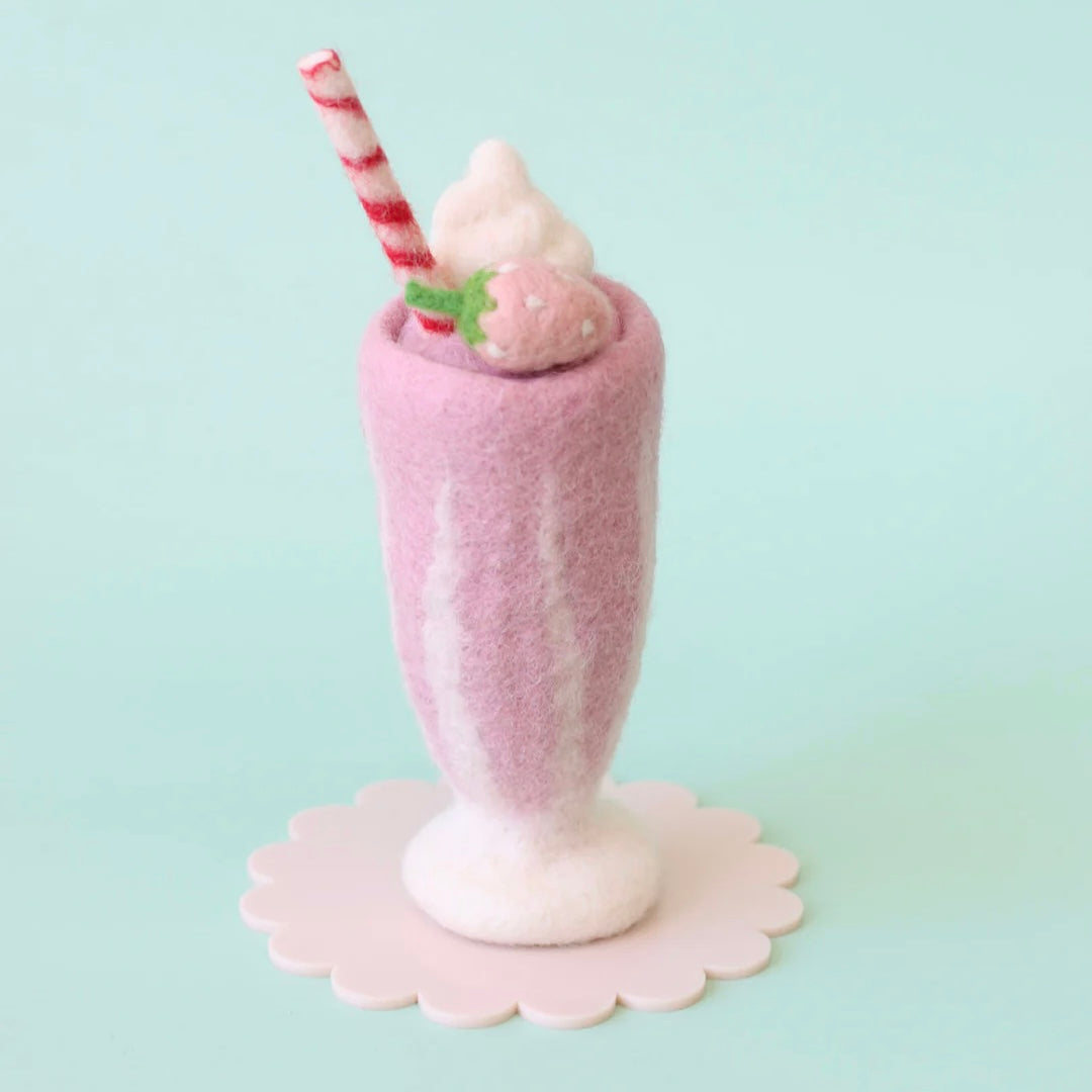 Felted pink milkshake with a straw and cherry on a light blue background