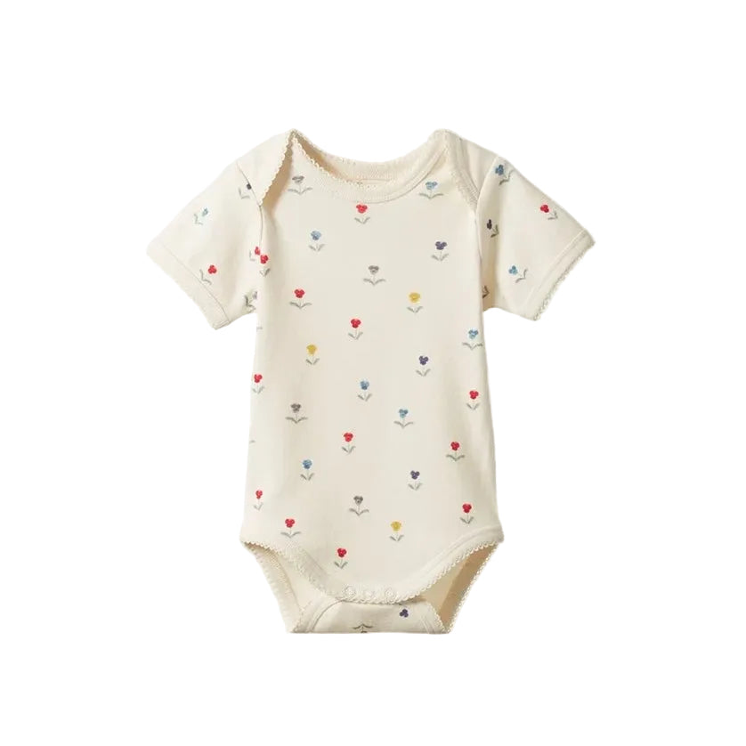 Baby onesie with colorful heart patterns on a light gray background