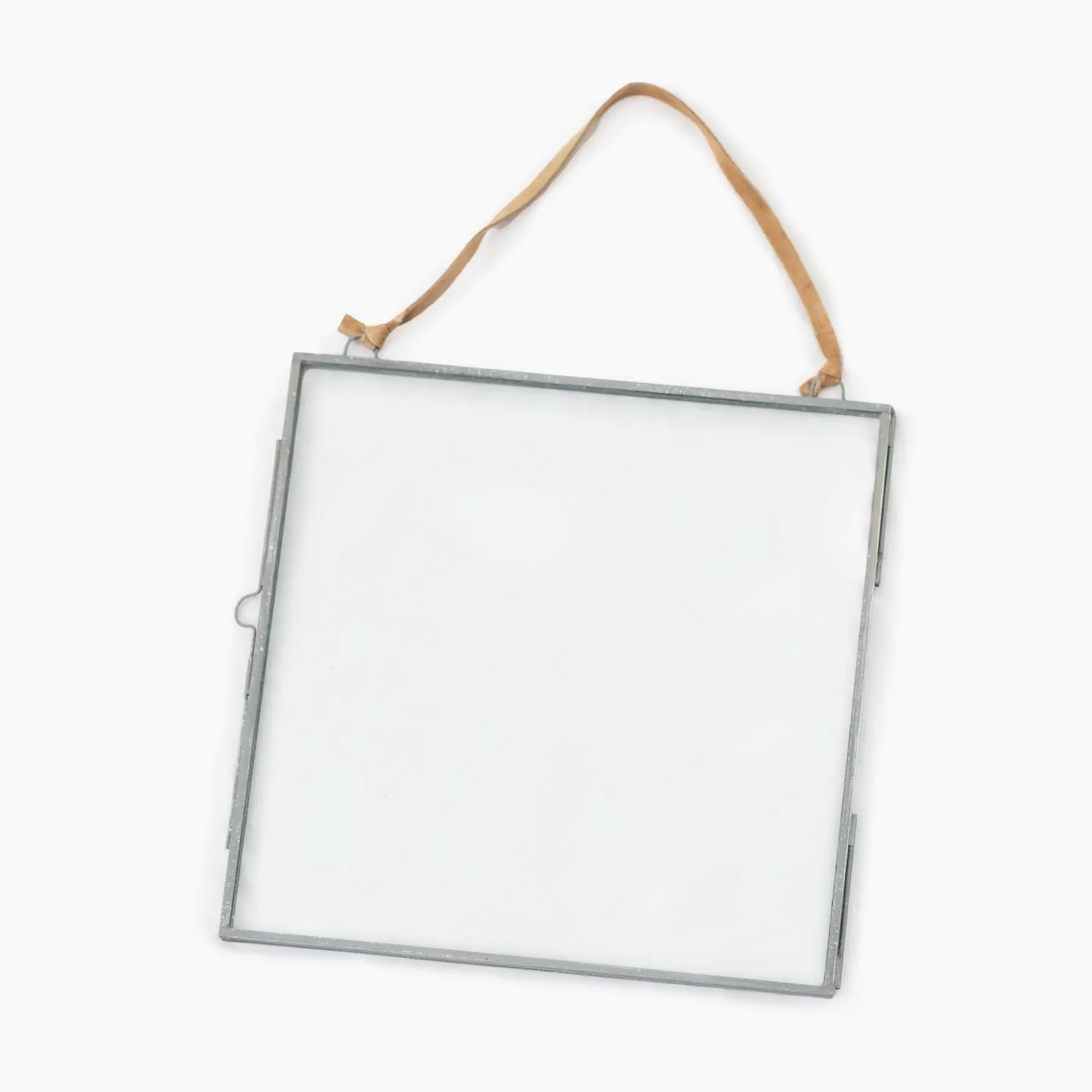 Clear glass panel with metal frame and brown string on a white background