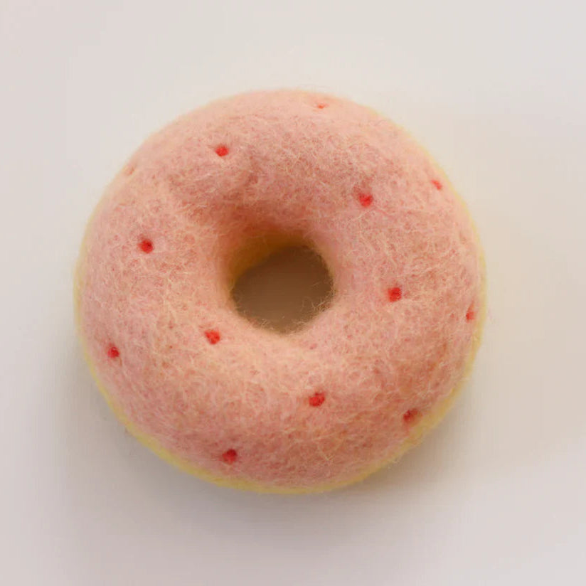 Pink donut with red spots on a white background