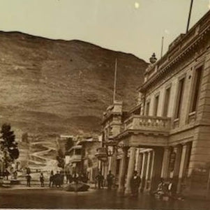 Vintage Queenstown street scene with the Eichardts Hotel building and mountains in the background
