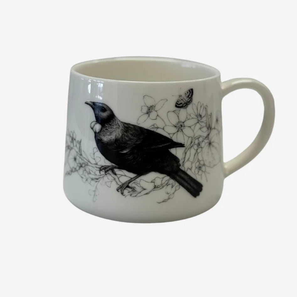 White mug with black Tui bird design by Katy Haywood on a white background