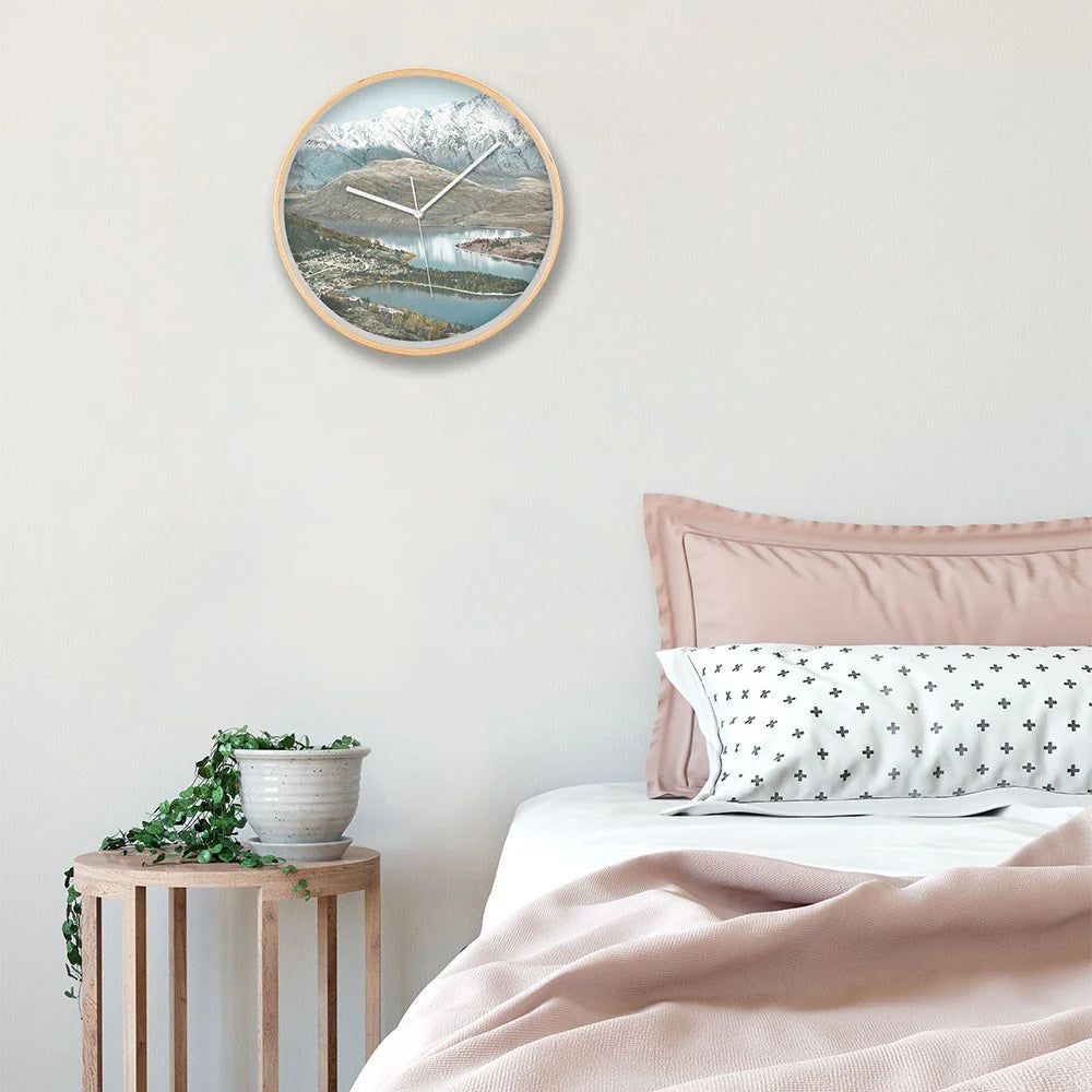 Wall clock with scenic design in a bedroom setting