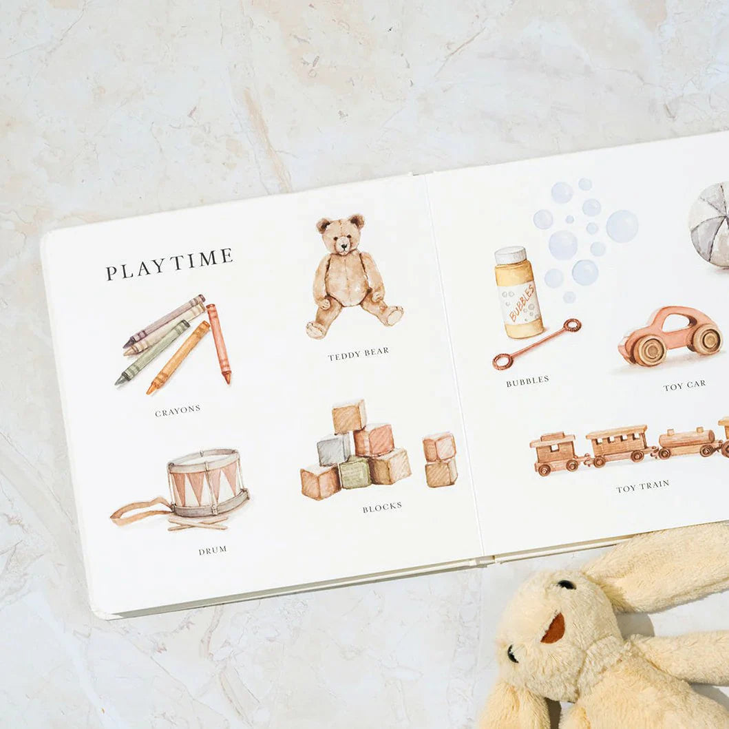 Children's book titled 'Playtime' with illustrations of toys on a marble surface.