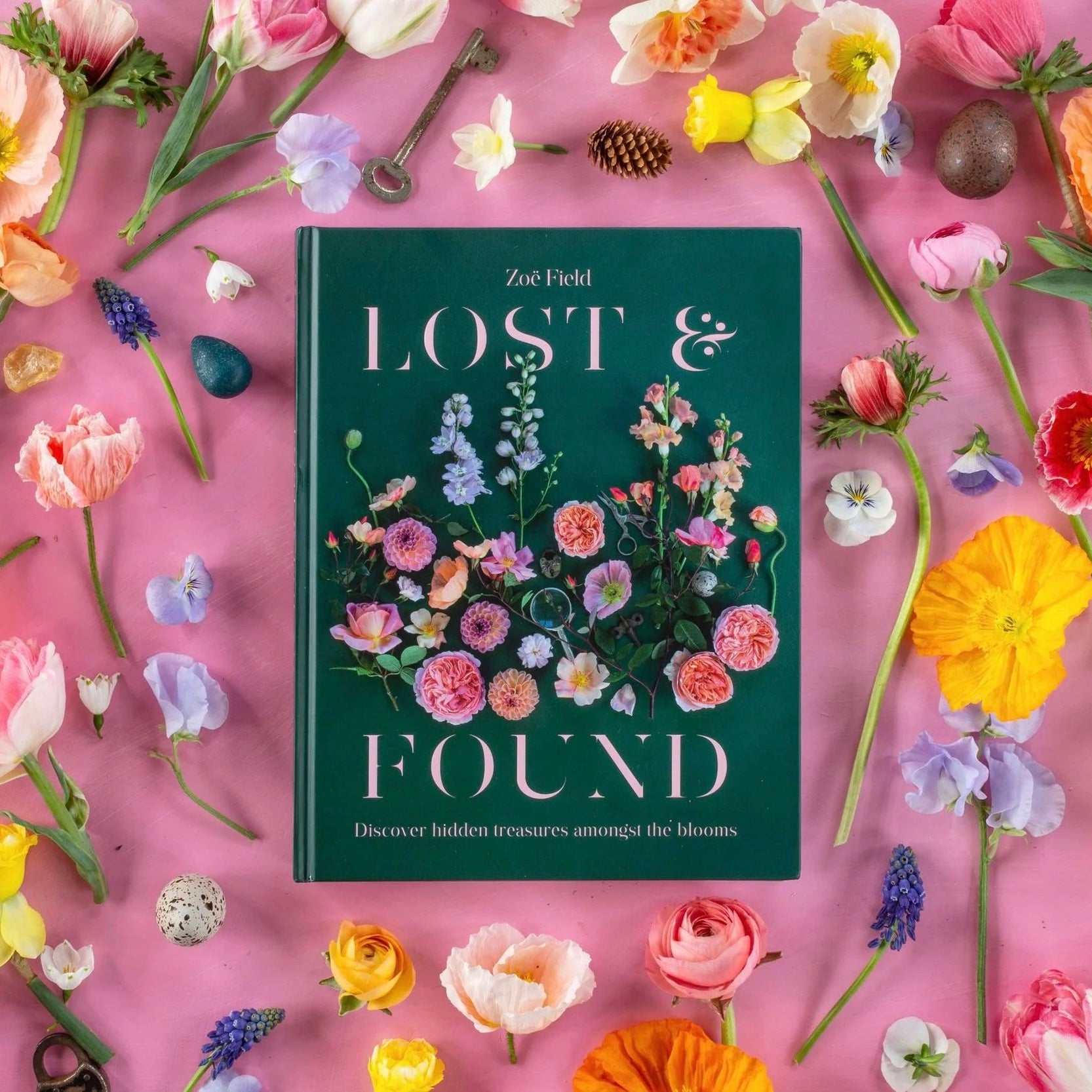 Book titled 'Lost & Found' by Zoe Field surrounded by colorful flowers on a pink background
