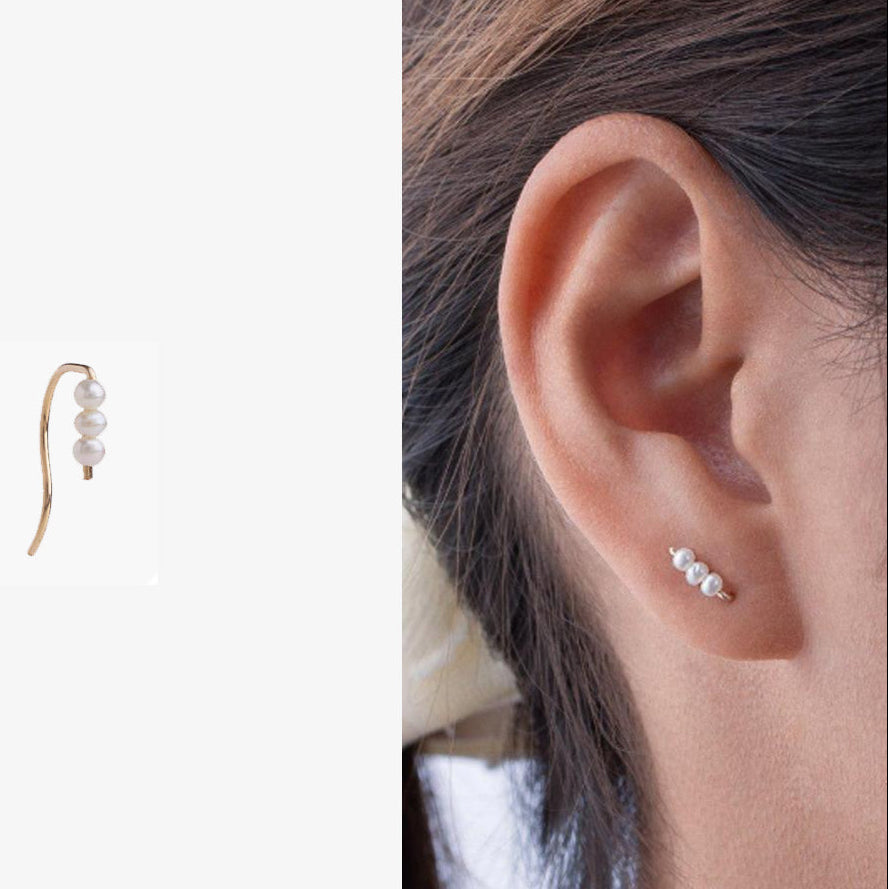 Pearl earrings displayed on a white background with a close-up of an ear wearing one of the earrings.