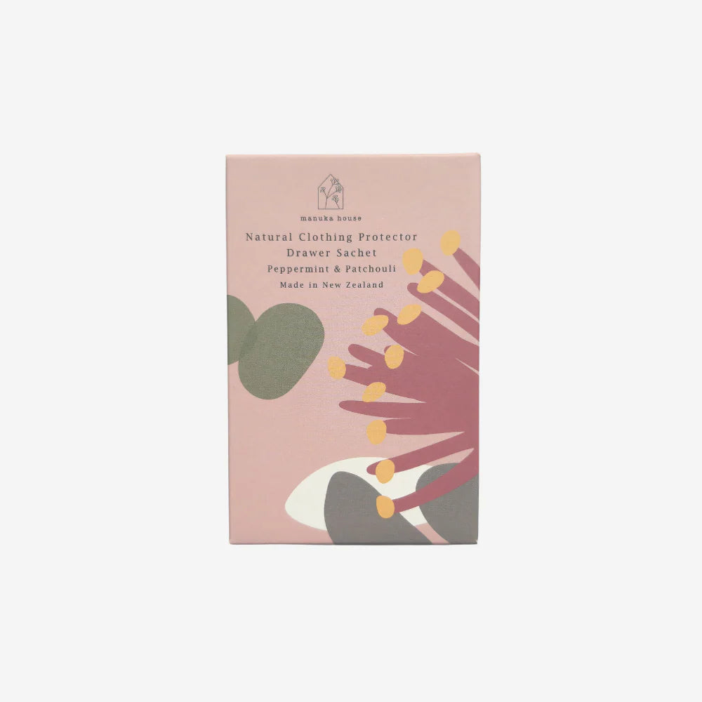 Package of a natural clothing protector with botanical design on a light pink background