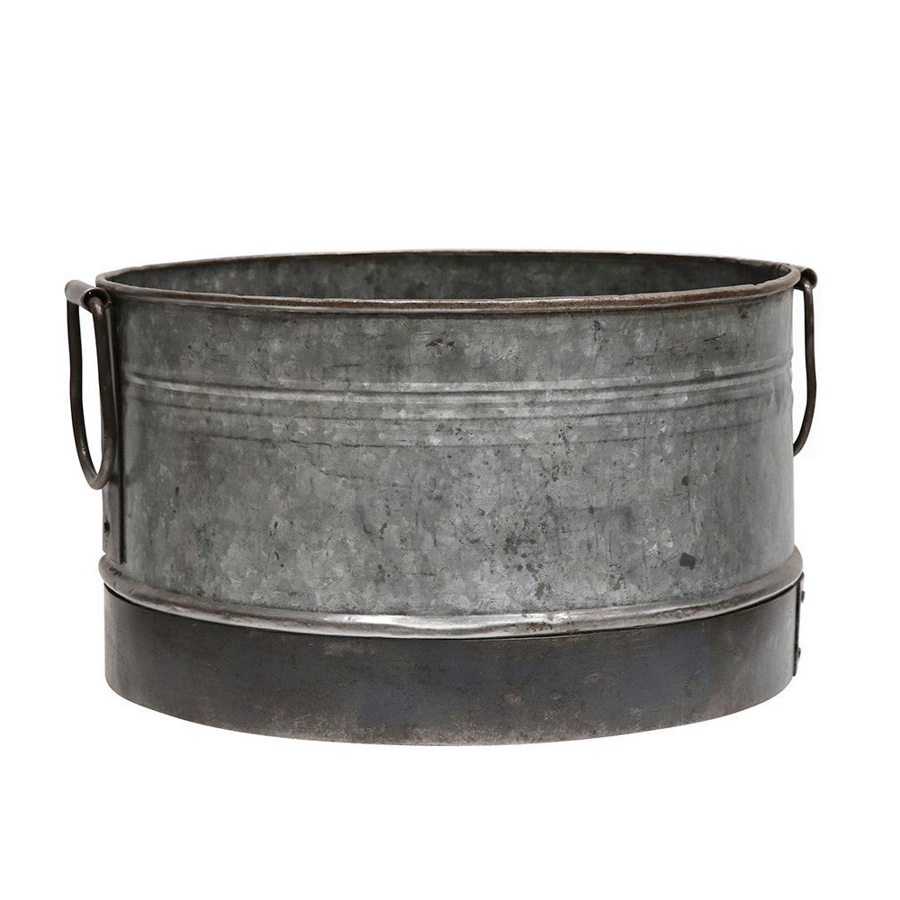 Metal basin with handles on a white background
