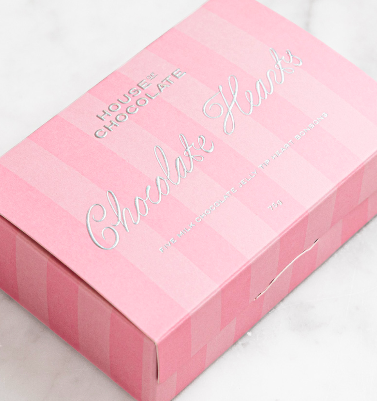 Pink chocolate box with 'House of Chocolate Hearts' text on a white background