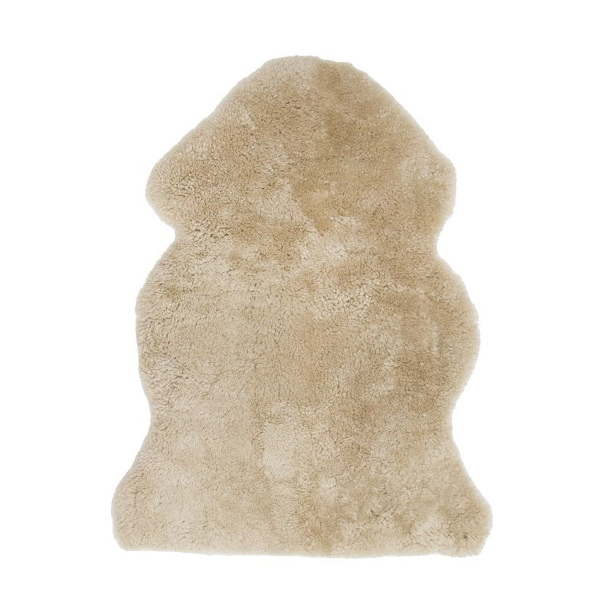 Beige sheepskin rug on a white background