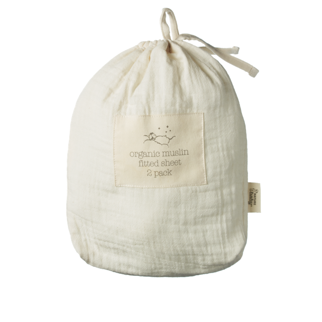 An off-white muslin fabric drawstring bag with a sewn-on label that reads 'organic muslin fitted sheet 2 pack' and a small side tag, photographed on a plain white background.
