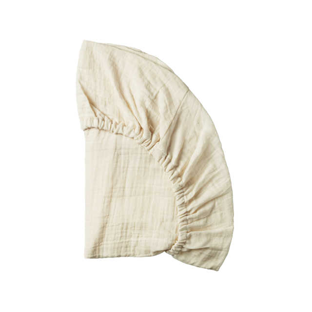 A cream-colored muslin baby sheets displayed on a clean white background.