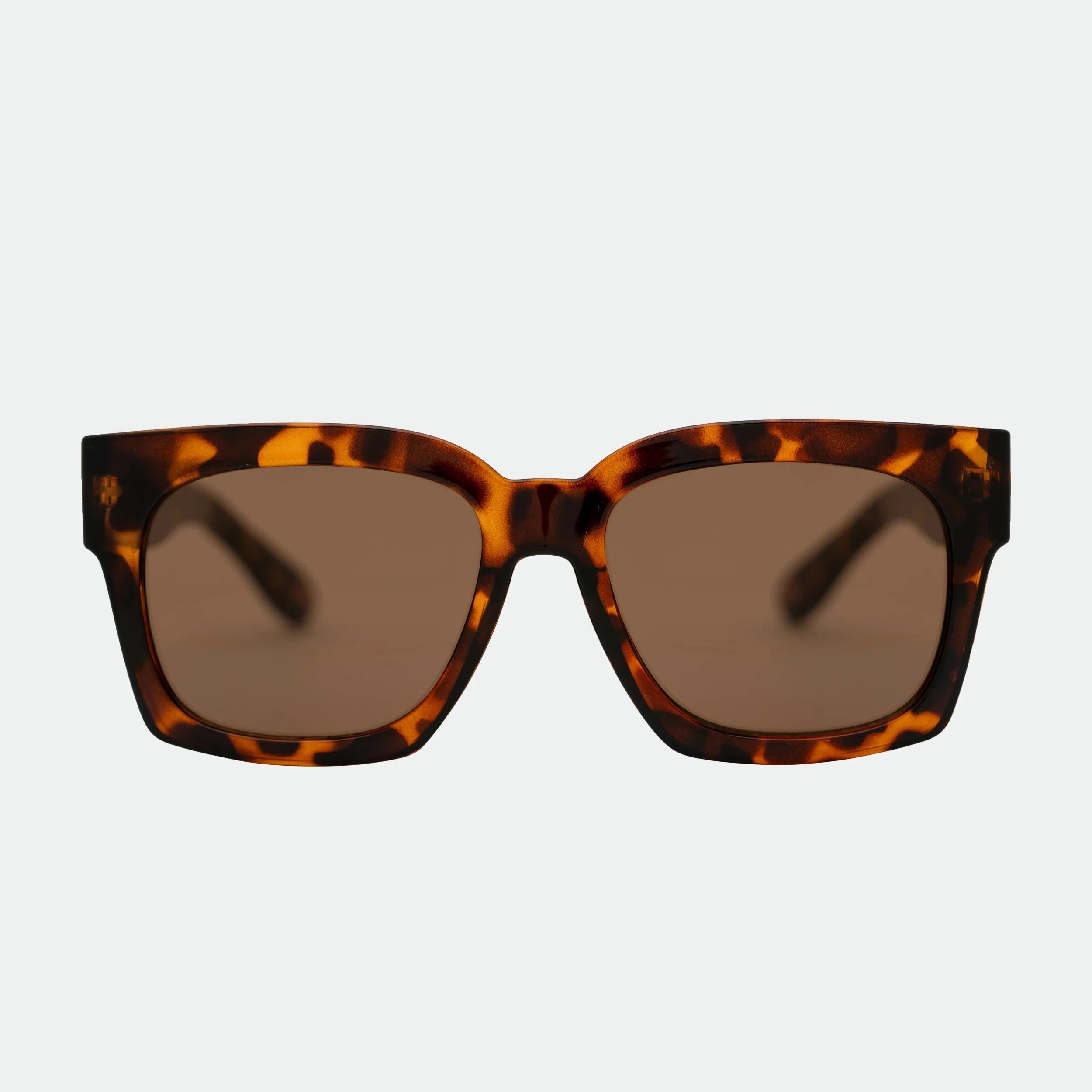 Sunglasses with tortoiseshell frame and brown lenses on a light gray background