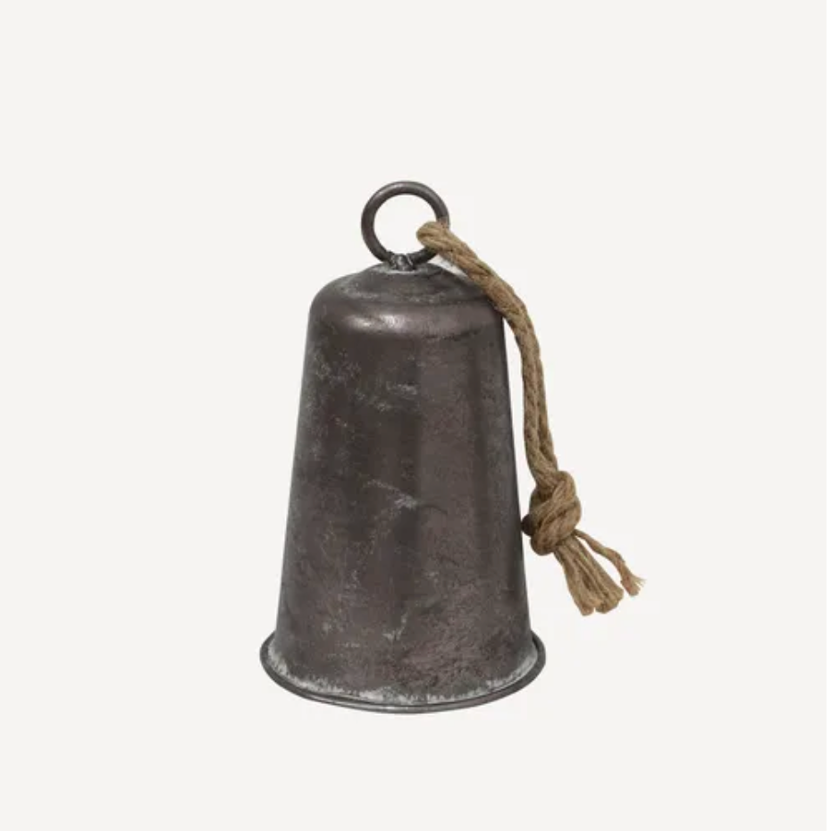 Vintage-style metal bell with a rope on a white background