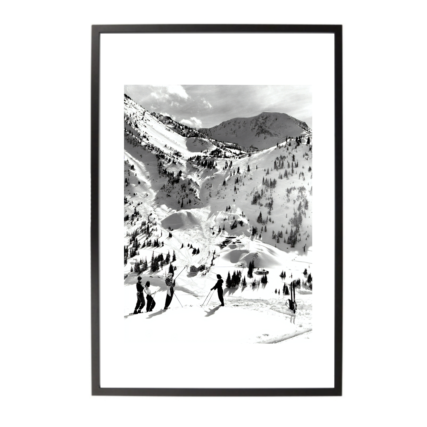 Framed black and white print of a snowy mountain landscape with skiers.