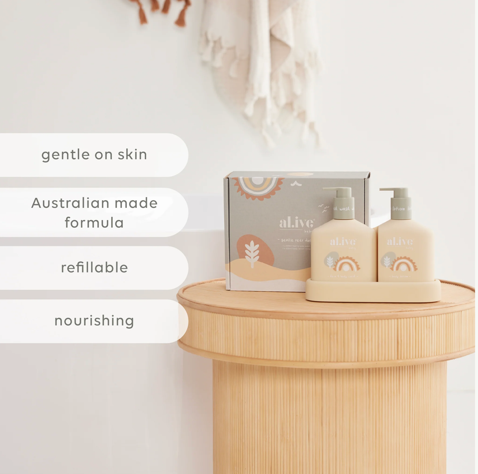 A set of two refillable baby lotion bottles and a matching box from the brand al ive, styled on a light wood pedestal with marketing text overlays on the left.