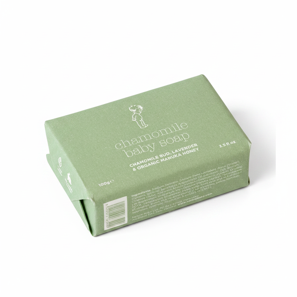 Green packaging of chamomile baby soap on a white background
