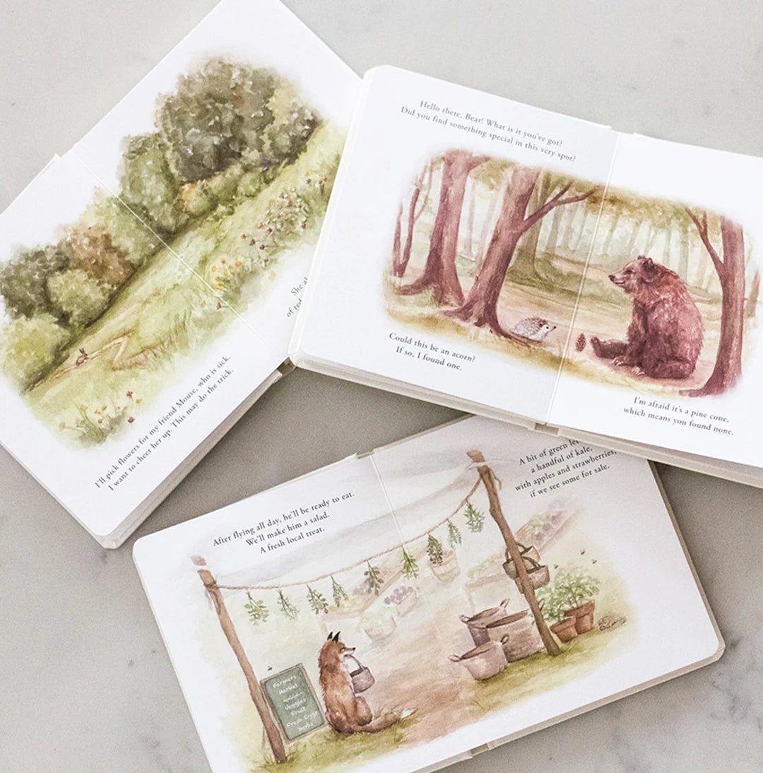Open children's book with illustrations of a bear in a forest setting