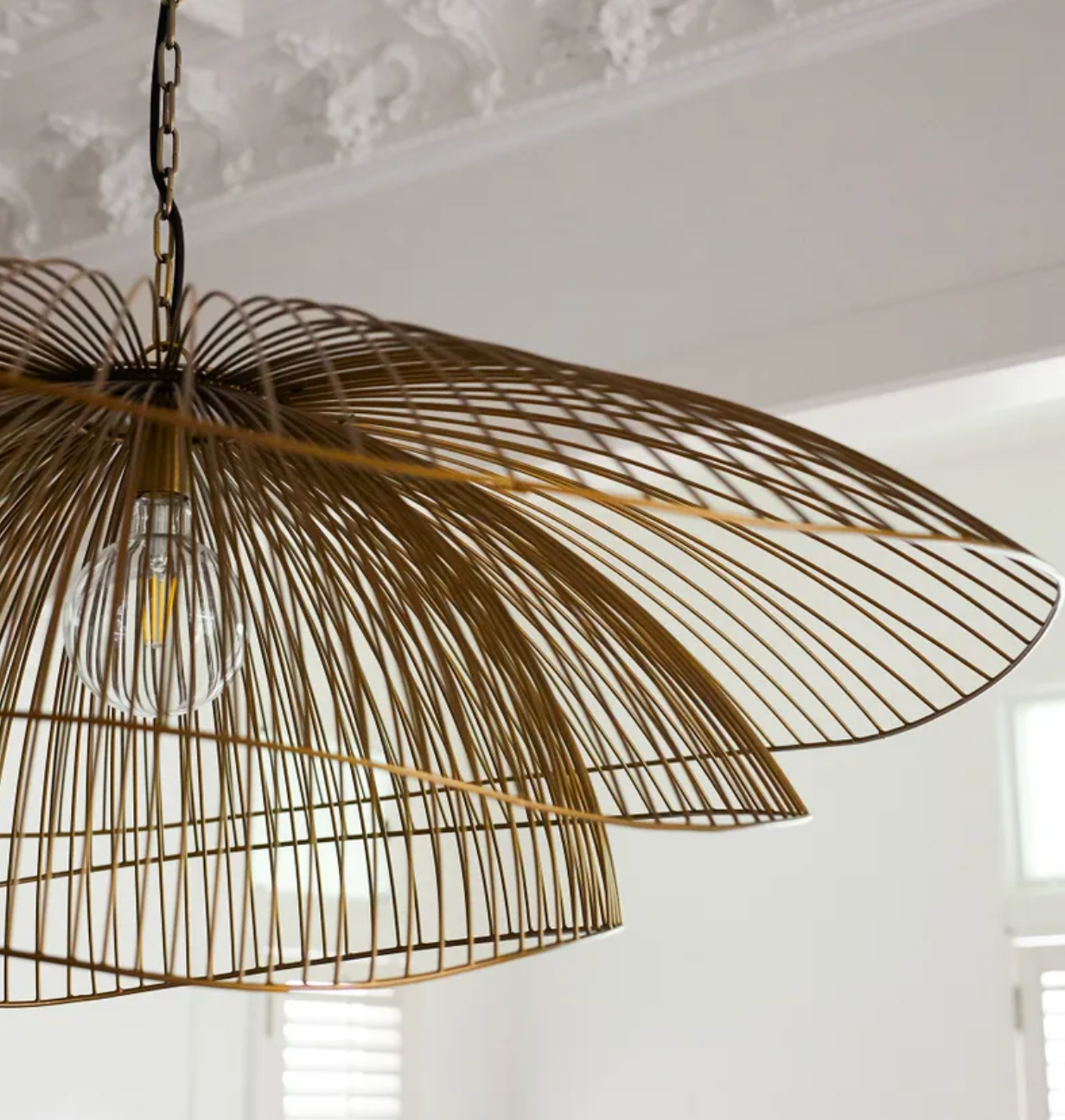 Decorative pendant light with wicker design in a room setting