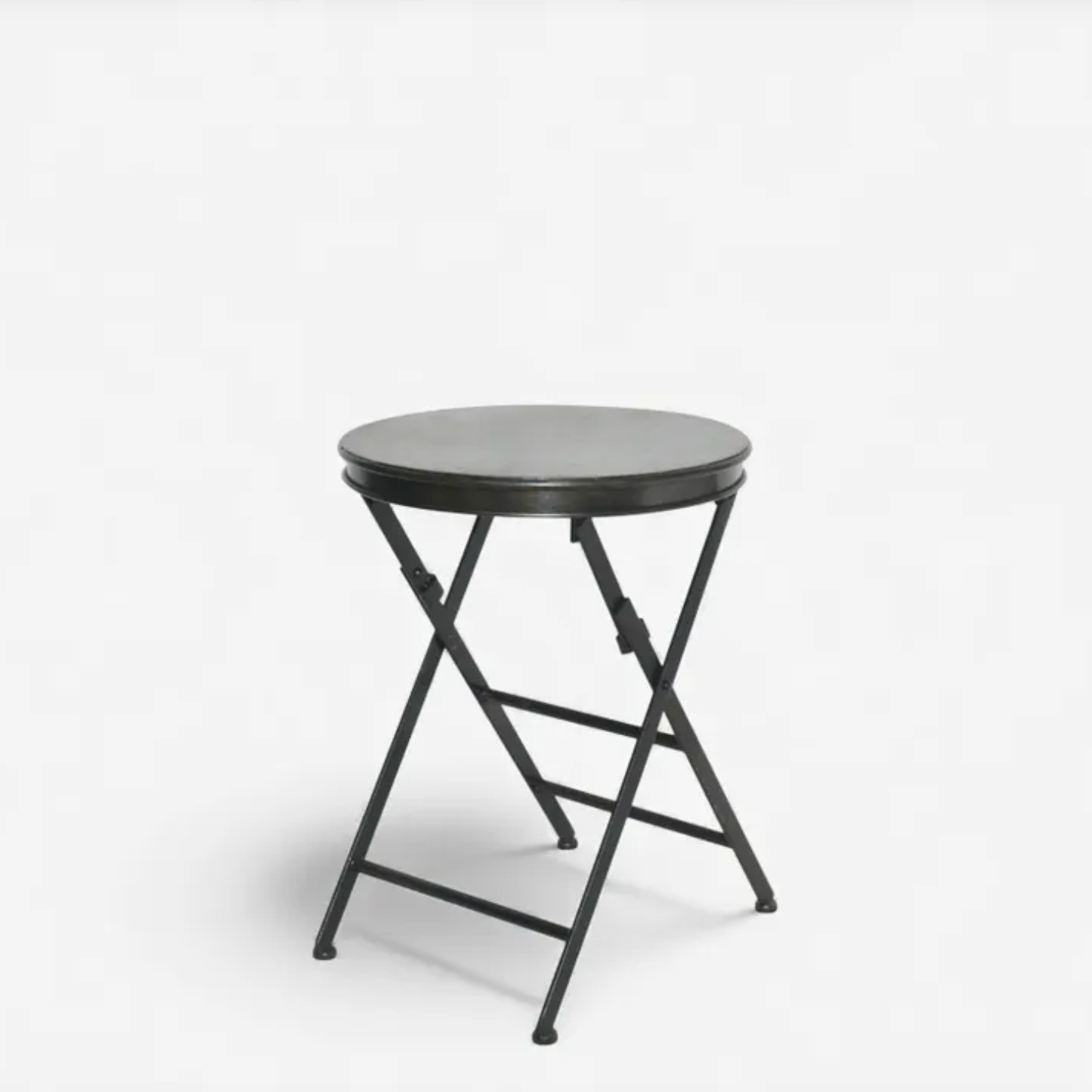 Small round folding table with black metal frame on a white background