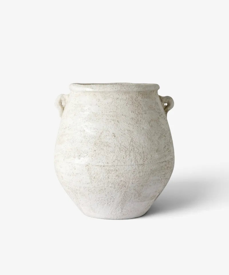 A rustic ceramic pot with a textured, speckled off-white glaze and small loop handles on both sides, photographed on a clean white background.