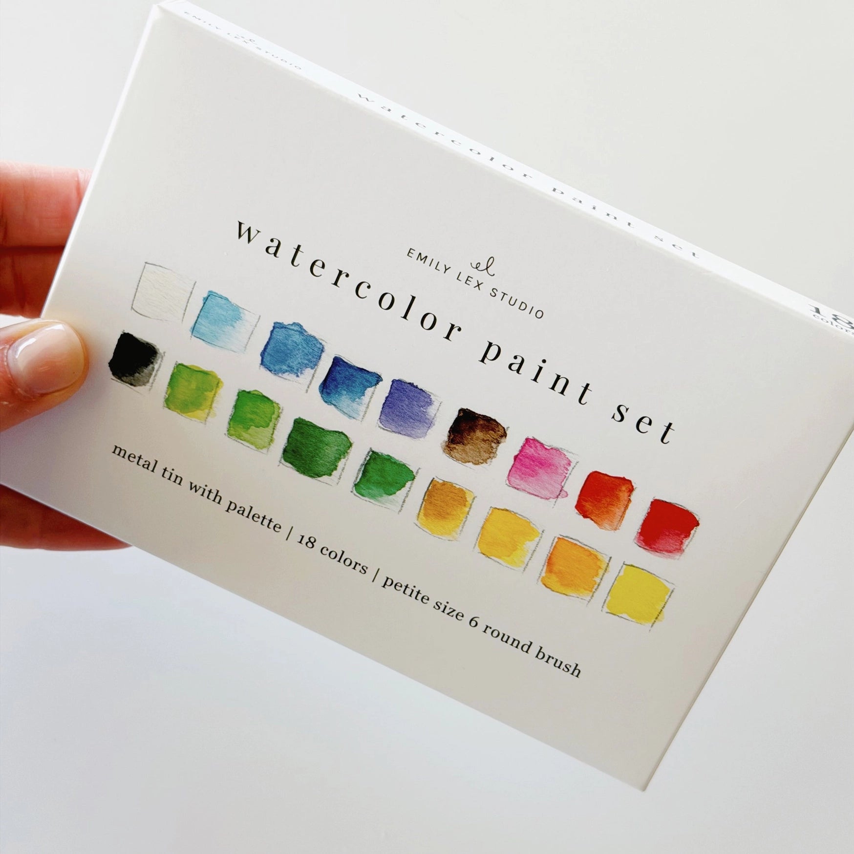 Watercolor paint set with color swatches on a white background