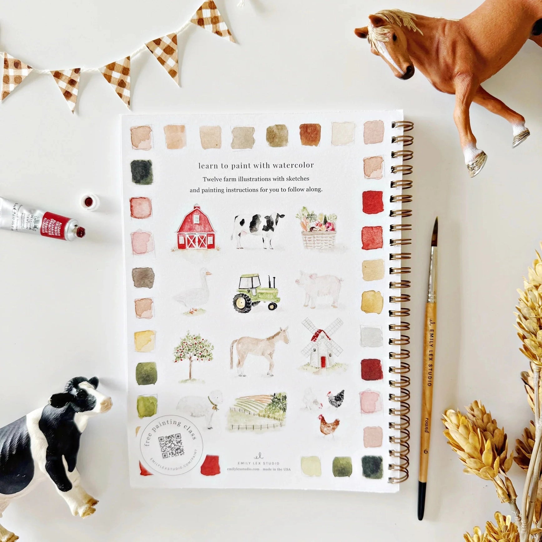 paint book with farm illustrations on a white surface with decorative elements.