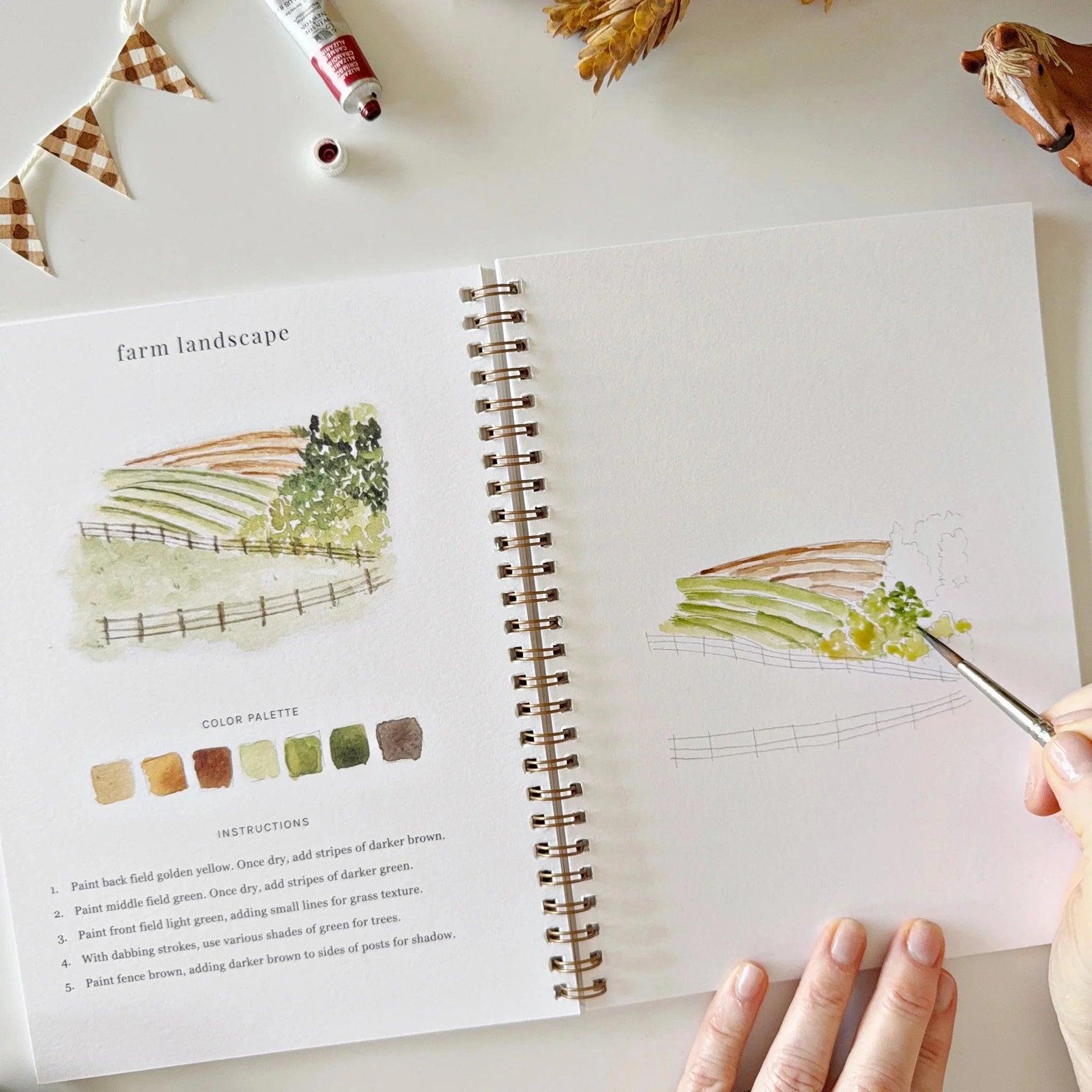 Artistic sketchbook with illustrations and color palette on a table