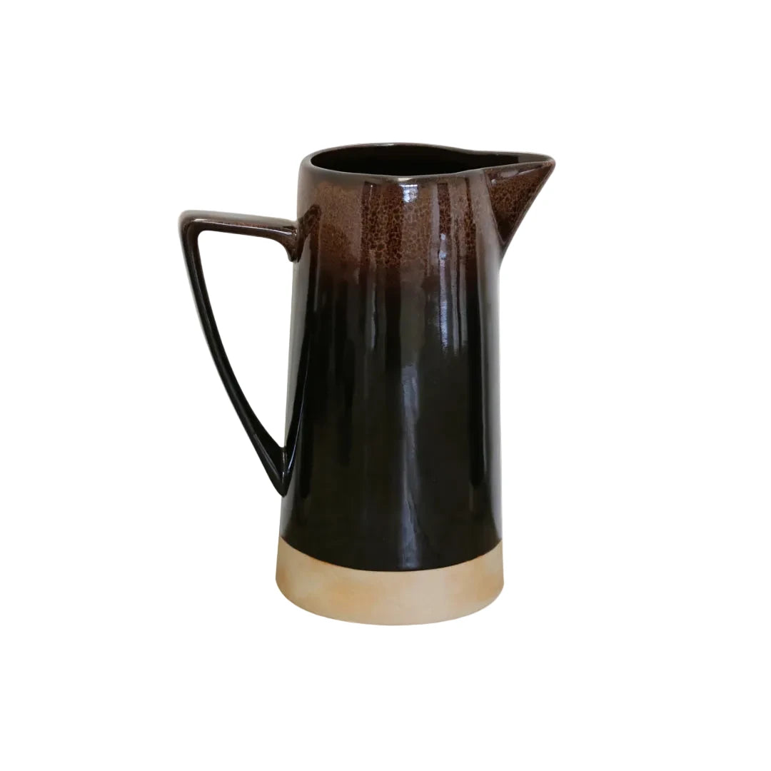 Black ceramic pitcher on a light gray background