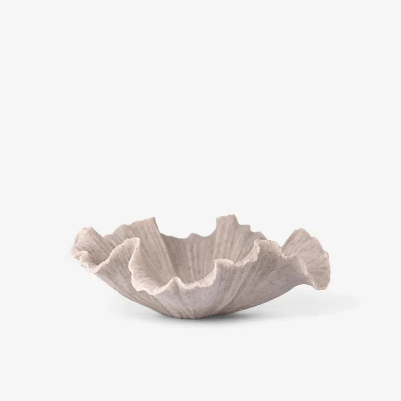 Ceramic bowl with shell design on a white background