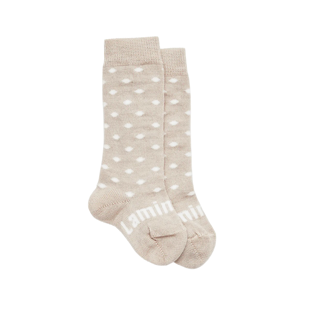 Pair of beige merino wool socks with white polka dots on a white background