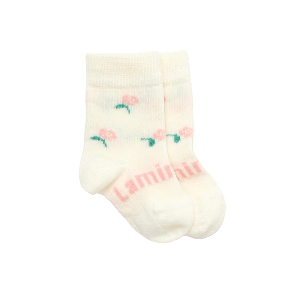 White baby sock with pink floral designs and 'Lamington' branding on a white background