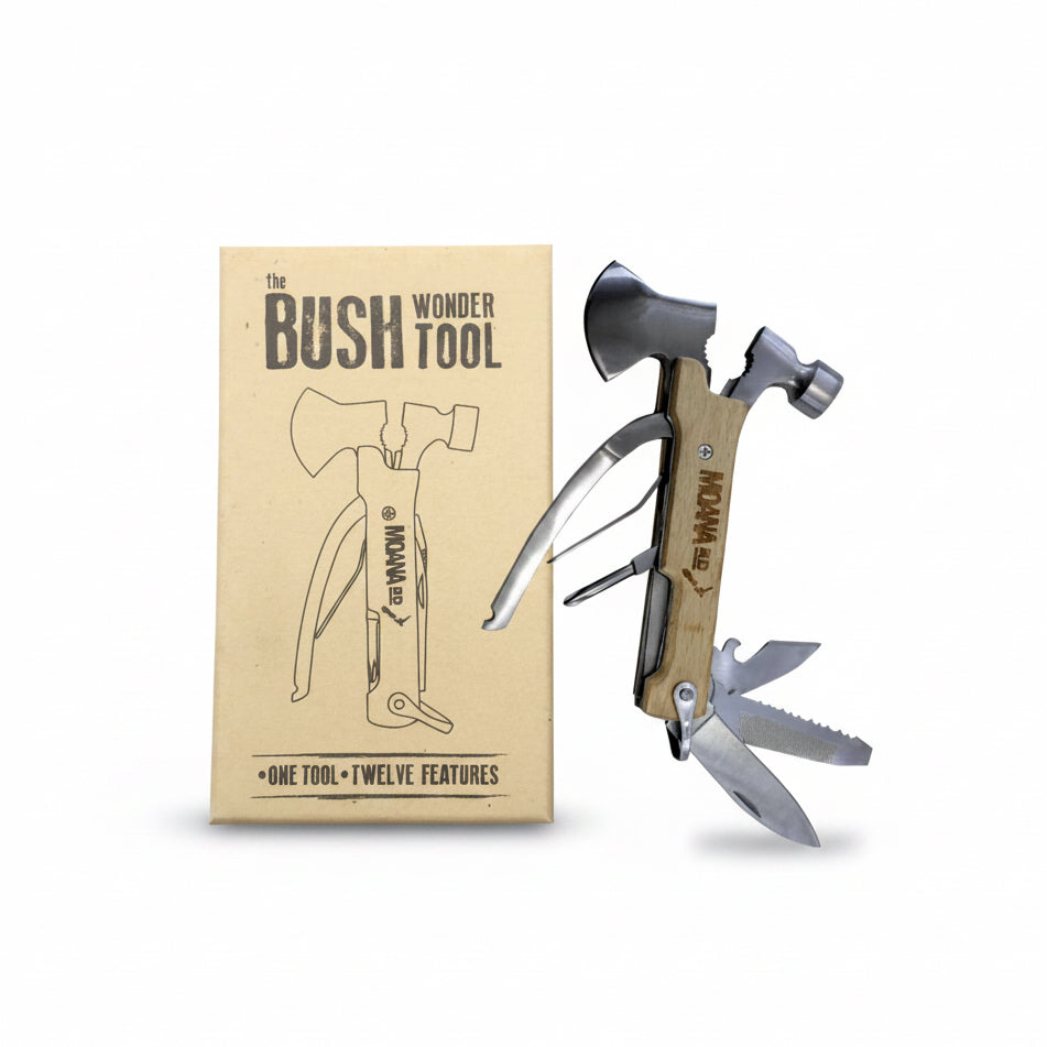 Multitool with axe head and hammer function on a cardboard box labeled 'The Bush Wonder Tool'.