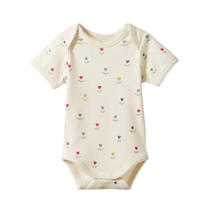Baby onesie with colorful heart patterns on a light gray background