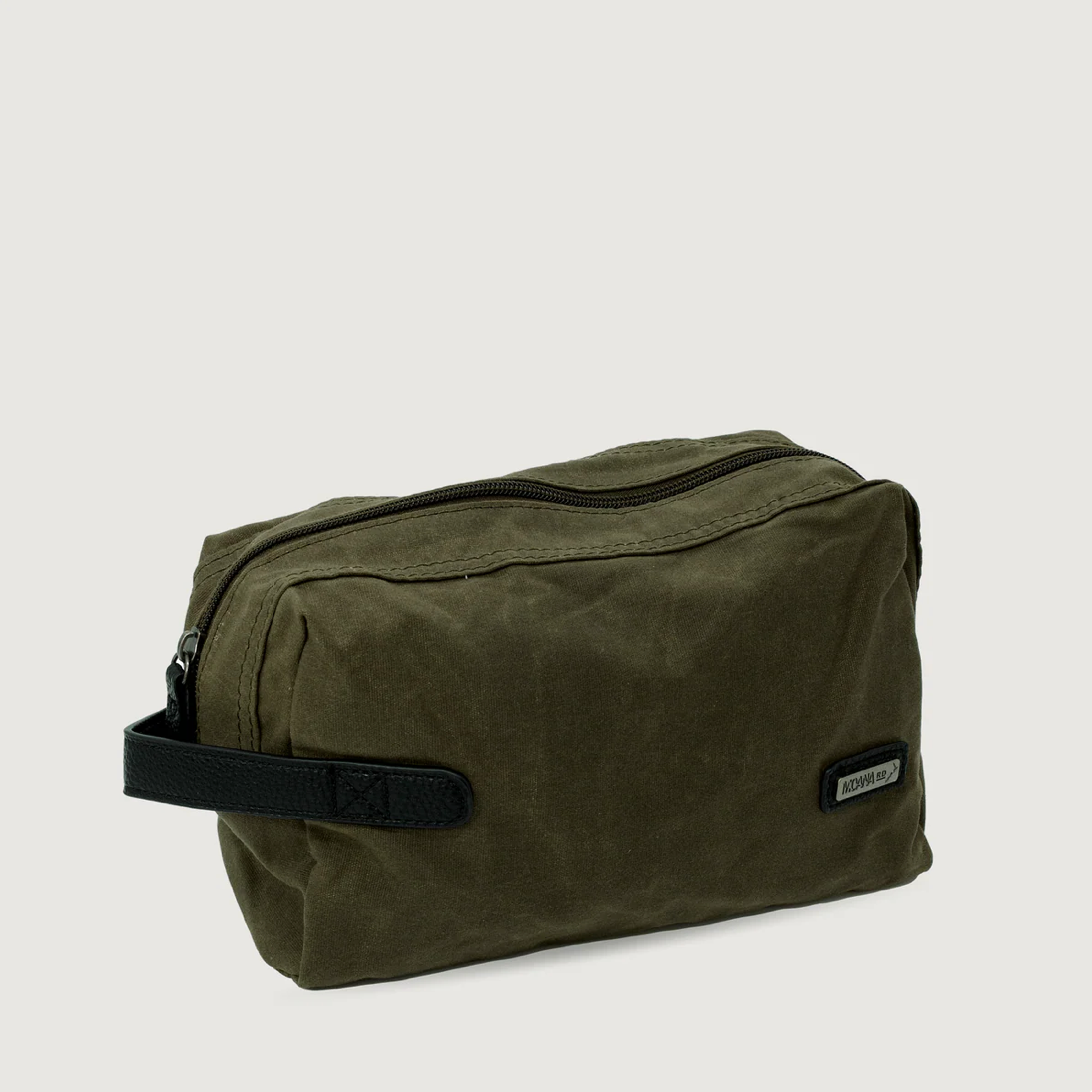 Green toiletry bag with a black handle on a light gray background