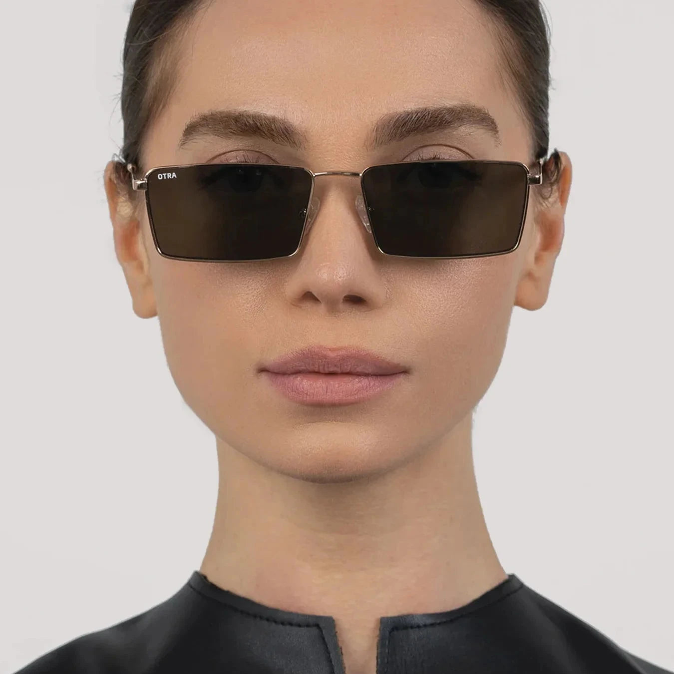Person wearing dark sunglasses against a plain background