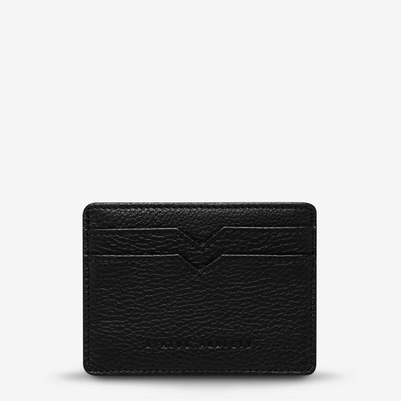 Black leather cardholder on a light gray background