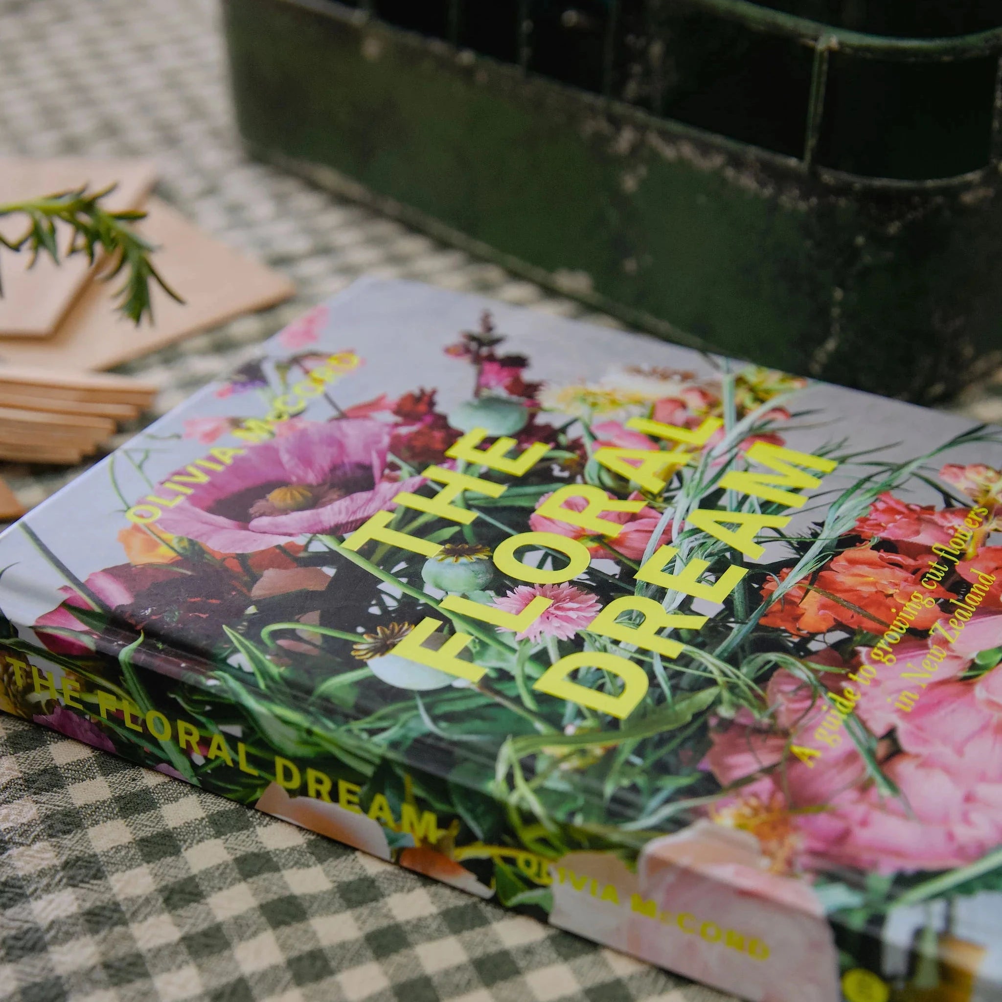 Book titled 'The Floral Dream' on a checkered surface