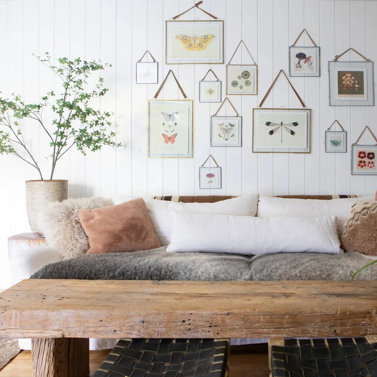 Living room with a wooden table, sofa, and wall art