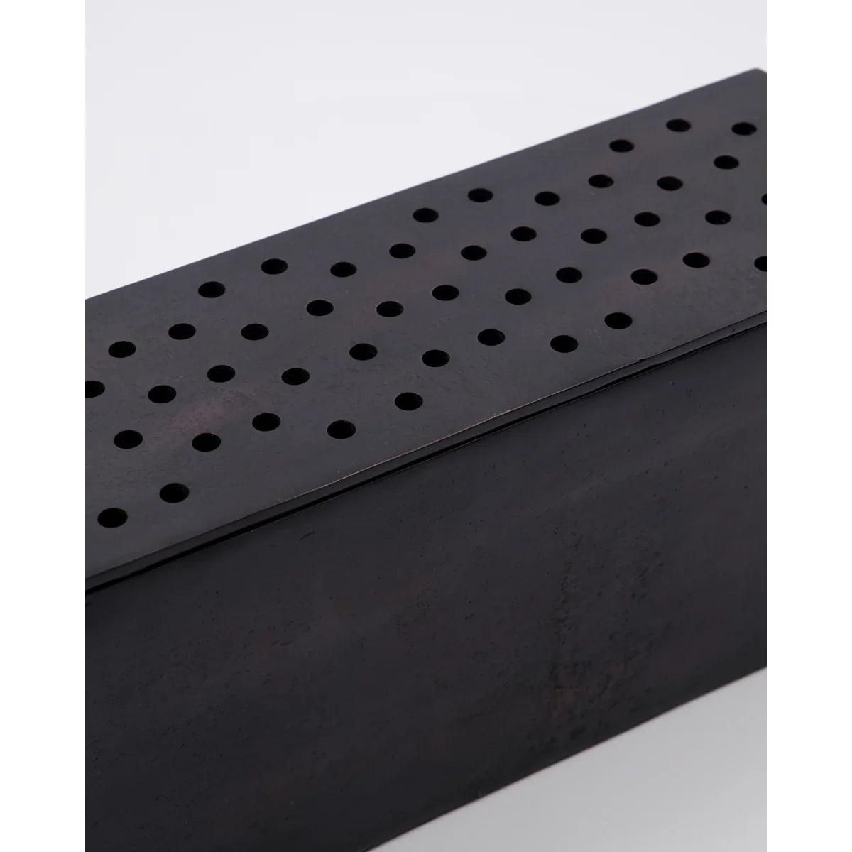Black metal vase or flower holder perforated design on a white background